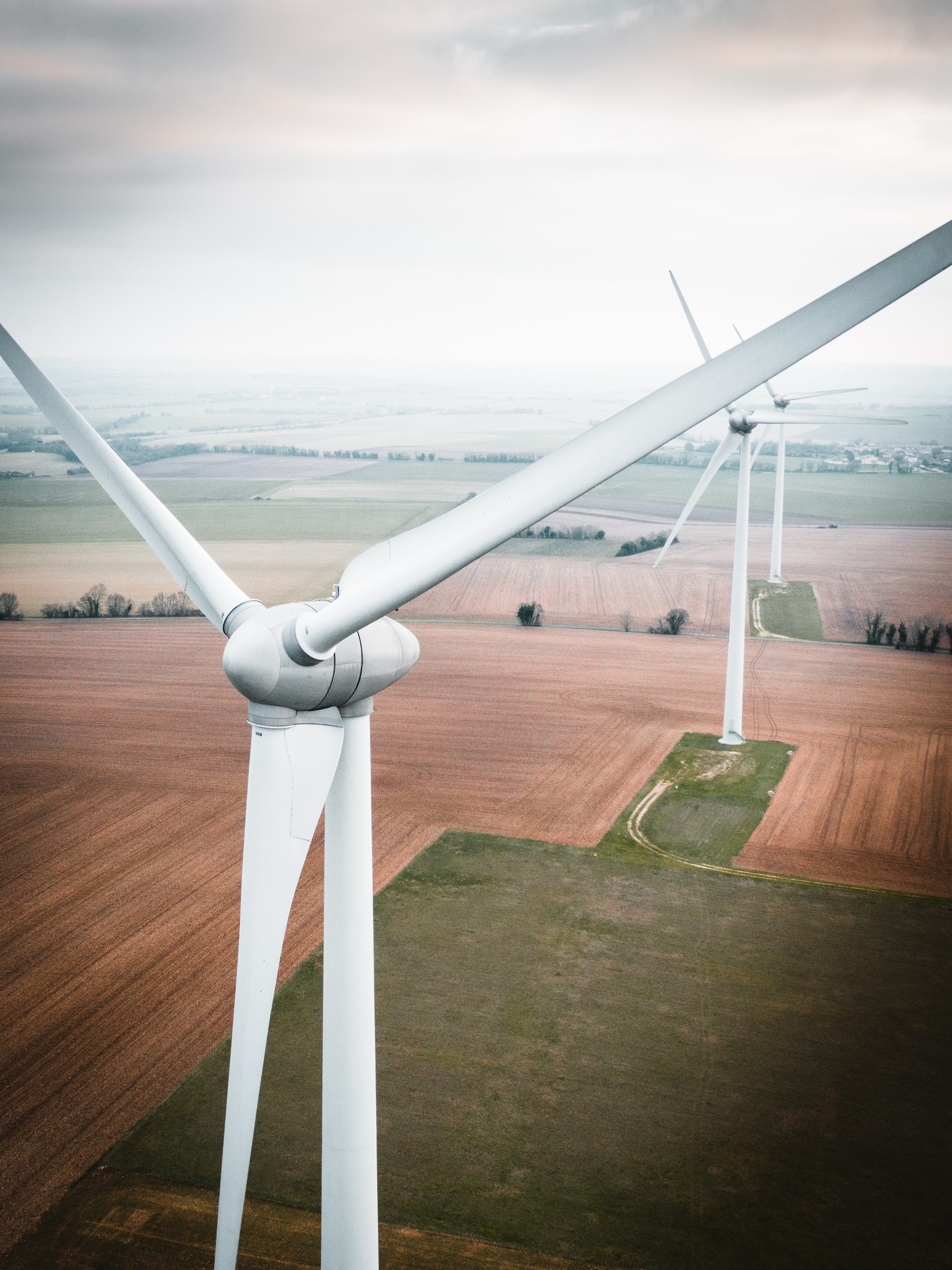 Three white windmills during daytime. 