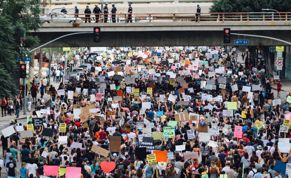 A large group of people holding up signs.