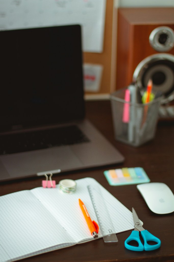 Stationary scattered on a wooden table.