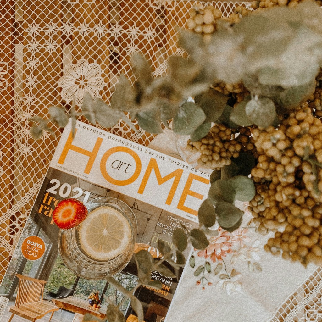 Art home magazine on a table next to flowers. 